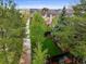 Elevated backyard view showcases the meticulously maintained lawn, complemented by mature trees for added privacy and shade at 7927 Elmwood St, Littleton, CO 80125