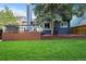 A spacious wooden deck extends from a home with a lush, green lawn and mature trees, perfect for outdoor enjoyment at 7927 Elmwood St, Littleton, CO 80125