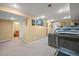 Spacious finished basement, carpeted with neutral colors and recessed lighting at 7927 Elmwood St, Littleton, CO 80125