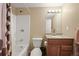 Standard bathroom features a shower-tub combo, single sink vanity, and neutral paint at 7927 Elmwood St, Littleton, CO 80125