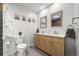 Bright bathroom with double vanity and modern finishes at 7927 Elmwood St, Littleton, CO 80125