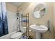 Bright bathroom with shower, sink, and blue accents at 7927 Elmwood St, Littleton, CO 80125