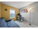 Bright bedroom featuring a futon, window, and a desk setup for an office space at 7927 Elmwood St, Littleton, CO 80125