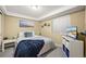 Cozy bedroom featuring a comfortable bed, soft lighting, and a window at 7927 Elmwood St, Littleton, CO 80125