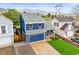 Charming blue two-story home featuring an attached garage, a cozy porch, and a well-maintained lawn at 7927 Elmwood St, Littleton, CO 80125