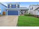 Attractive two-story home with a welcoming front porch and lush green lawn at 7927 Elmwood St, Littleton, CO 80125