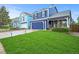 Beautiful two-story home with a vibrant blue exterior and manicured landscaping at 7927 Elmwood St, Littleton, CO 80125