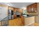 Modern kitchen features stainless steel appliances, granite countertops, and wood cabinets at 7927 Elmwood St, Littleton, CO 80125