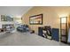 Comfortable living room with a fireplace, plush sofa, and entertainment center at 7927 Elmwood St, Littleton, CO 80125