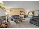 Spacious living room featuring a brick fireplace, comfortable seating, and ample natural light at 7927 Elmwood St, Littleton, CO 80125