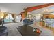 Spacious living room with large windows, carpet floors, neutral paint, and an adjacent kitchen at 7927 Elmwood St, Littleton, CO 80125