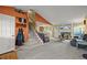 Cozy living room with a fireplace, open staircase, and modern decor at 7927 Elmwood St, Littleton, CO 80125