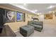 Finished basement with posters, neutral walls, and a comfortable couch at 7927 Elmwood St, Littleton, CO 80125