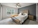 Comfortable main bedroom with a large window, ceiling fan, and neutral color palette at 7927 Elmwood St, Littleton, CO 80125