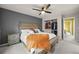 Bedroom with a walk-in closet, ceiling fan, and neutral decor at 7927 Elmwood St, Littleton, CO 80125