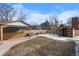 Large backyard with patio, shed, and mature trees at 7628 S Cedar Cir, Littleton, CO 80120