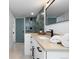 Stylish bathroom with white vanity and gray tile shower at 7628 S Cedar Cir, Littleton, CO 80120