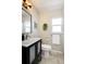Bathroom vanity with sleek black accents, complemented by modern fixtures and a window for natural light at 3469 Benton St, Wheat Ridge, CO 80212