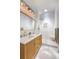 Modern bathroom features a double vanity, glass shower, and stylish lighting at 3469 Benton St, Wheat Ridge, CO 80212