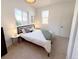 Well-lit bedroom with a comfortable bed, stylish side tables, and ample natural light from windows at 3469 Benton St, Wheat Ridge, CO 80212