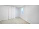 Clean bedroom featuring white walls, carpet flooring, and a closet with double doors at 3469 Benton St, Wheat Ridge, CO 80212