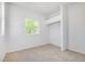 Bright bedroom features a large window and neutral carpet, creating a serene atmosphere at 3469 Benton St, Wheat Ridge, CO 80212