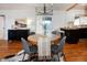 Open dining room featuring a modern light fixture, hardwood floors, and a view of the backyard at 3469 Benton St, Wheat Ridge, CO 80212