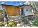 Inviting home featuring wood paneling, black trim, front porch and freshly landscaped front yard at 3469 Benton St, Wheat Ridge, CO 80212