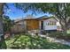 Beautiful single-story home featuring wood paneling, manicured front yard, and an inviting entry at 3469 Benton St, Wheat Ridge, CO 80212