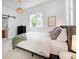 Bright main bedroom with a barn door to the bathroom and large windows at 3469 Benton St, Wheat Ridge, CO 80212