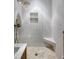 Walk-in shower features white subway tile, mosaic floors, and bronze shower fixtures at 3469 Benton St, Wheat Ridge, CO 80212