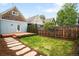 Spacious backyard featuring a well-manicured lawn, a wooden deck, and a stone pathway at 3425 W 34Th Ave, Denver, CO 80211