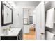 Half bath featuring elegant vanity, modern fixtures, and a view into another room at 3425 W 34Th Ave, Denver, CO 80211