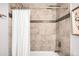 Tiled shower with chrome fixtures and rainfall showerhead, complemented by white shower curtain at 3425 W 34Th Ave, Denver, CO 80211