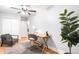 Bright bedroom with hardwood floors, neutral walls, a ceiling fan, and a comfortable seating area at 3425 W 34Th Ave, Denver, CO 80211