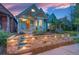 Charming home exterior with stone retaining wall and landscaped front yard at twilight at 3425 W 34Th Ave, Denver, CO 80211