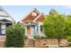 Charming single Gathering home with a quaint front yard featuring a stone retaining wall and unique wood shingle siding at 3425 W 34Th Ave, Denver, CO 80211
