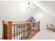 Hallway with hardwood railing and black iron spindles with view to the attic living space above at 3425 W 34Th Ave, Denver, CO 80211