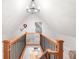 Hallway with hardwood railing and black iron spindles, with view to the kitchen below at 3425 W 34Th Ave, Denver, CO 80211