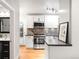 Modern kitchen with stainless steel appliances, white cabinetry, and stylish backsplash at 3425 W 34Th Ave, Denver, CO 80211
