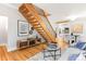 Open floor plan living room featuring a wooden staircase, hardwood floors, and modern decor at 3425 W 34Th Ave, Denver, CO 80211