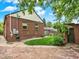 Brick home featuring a beautiful backyard with stone patio, lawn, and garden at 1247 Dexter St, Denver, CO 80220