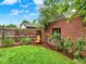 Landscaped backyard featuring a brick wall and wooden fence and comfortable garden chair at 1247 Dexter St, Denver, CO 80220