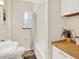 Well-lit bathroom featuring a vanity, toilet, bathtub with shower, and patterned floor tiles at 1247 Dexter St, Denver, CO 80220