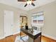 Bright bedroom with a desk, built-in shelving, natural light from a window, and ceiling fan at 1247 Dexter St, Denver, CO 80220