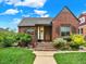 Charming brick home featuring a cozy front porch, well-maintained lawn, and inviting curb appeal under a clear blue sky at 1247 Dexter St, Denver, CO 80220