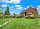 Charming brick home featuring a cozy front porch, well-maintained lawn, and inviting curb appeal on a bright, sunny day at 1247 Dexter St, Denver, CO 80220