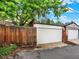 Two-car garage with white doors and a well-maintained driveway at 1247 Dexter St, Denver, CO 80220