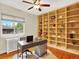 Functional home office features custom bookshelves, natural light, and a comfortable workspace at 1247 Dexter St, Denver, CO 80220
