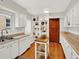 Well-designed kitchen with white cabinets, open shelving, and a functional island at 1247 Dexter St, Denver, CO 80220